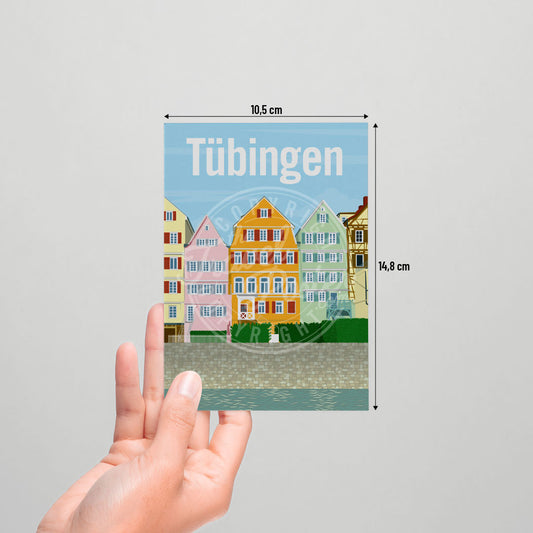 A hand holding a postcard of the Tübingen Neckar Riverfront on a white background.