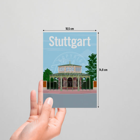 A hand holding a postcard of the Stuttgart Wilhelma Kassenpavillon on a white background.