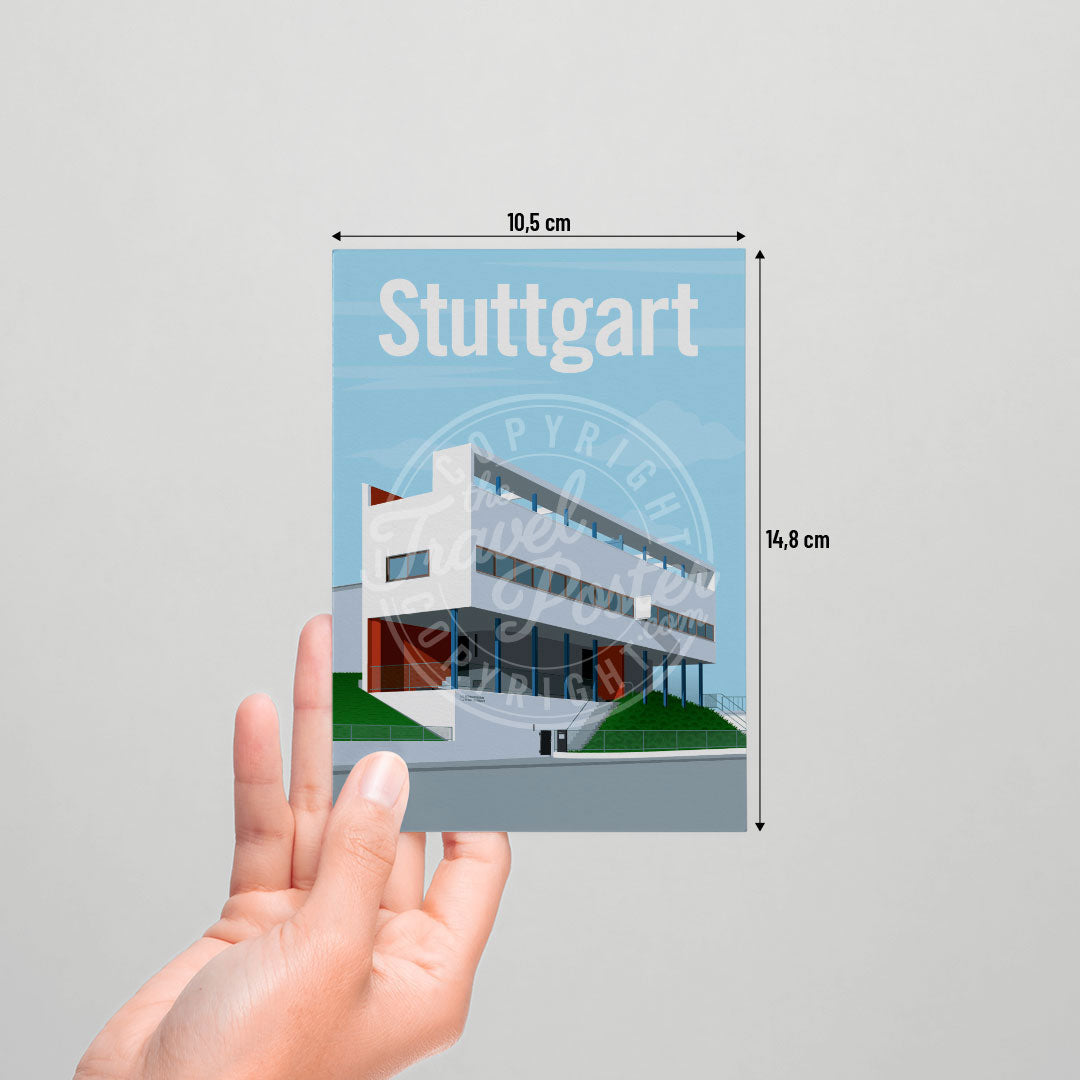 A hand holding a postcard of the Stuttgart Weissenhof Museum on a white background.