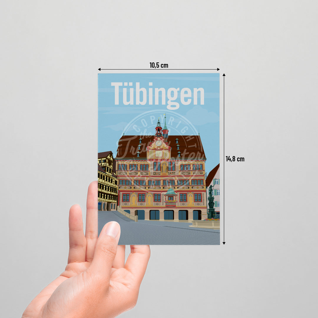 A hand holding a postcard of the Tübingen Rathaus on a white background.