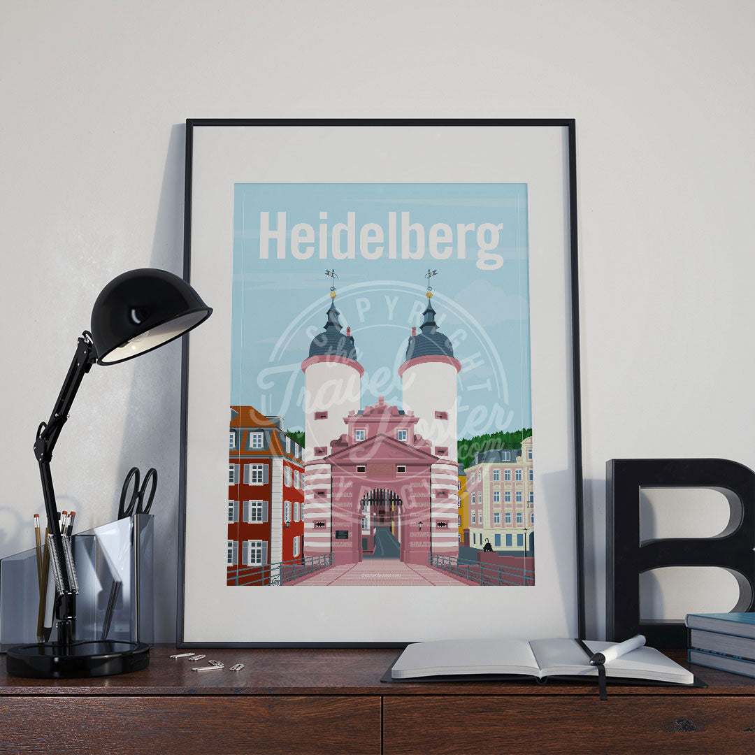 a frame with a poster of the Heidelberg Bridge Gate, placed a wooden sideboard with a table lamp and stationery supplies