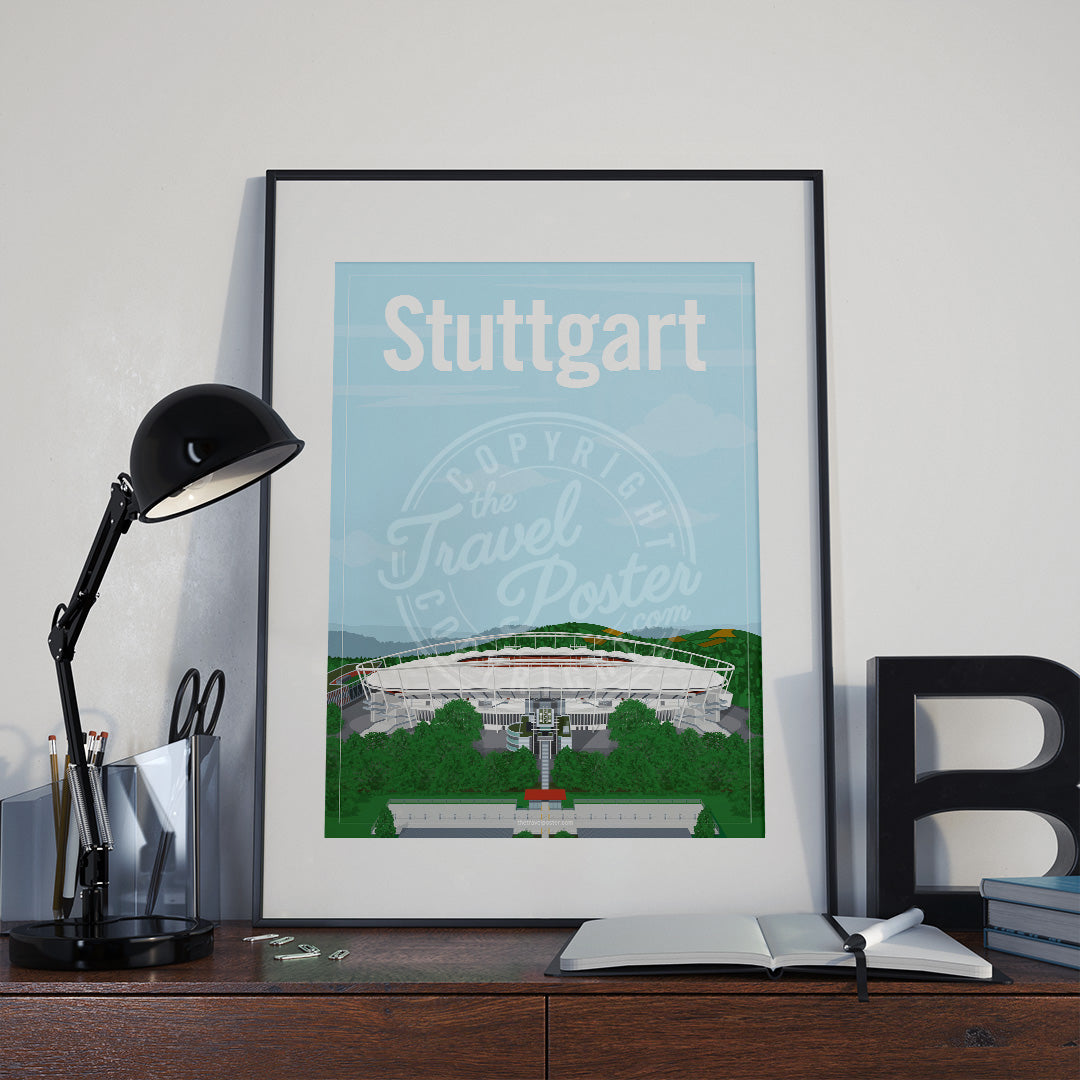 a frame with a poster of the Stuttgart Neckarstadion, placed a wooden sideboard with a table lamp and stationery supplies
