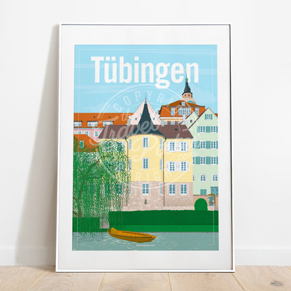 a frame with a poster of the Tübingen Holderlinturm, placed on a parquet floor resting against a white wall