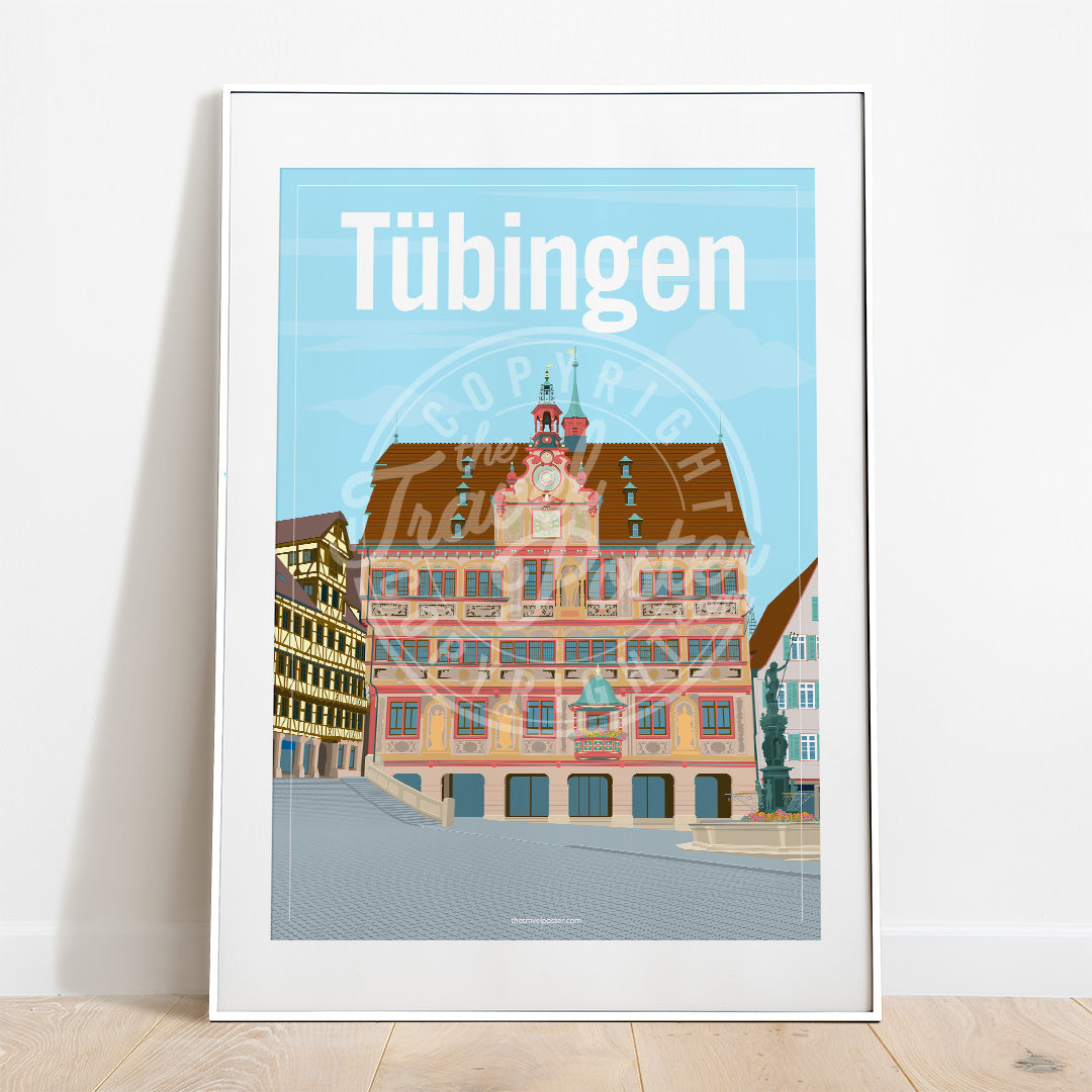 a frame with a poster of the Tübingen Rathaus, placed on a parquet floor resting against a white wall